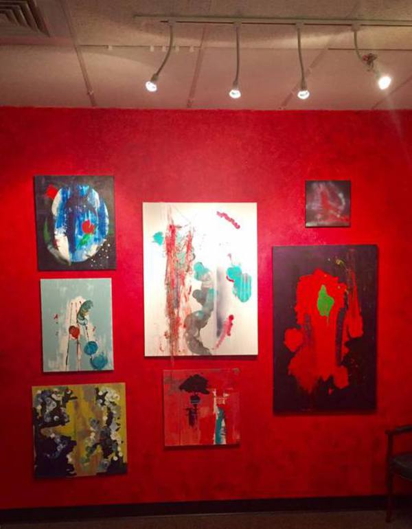 View of paintings on red wall